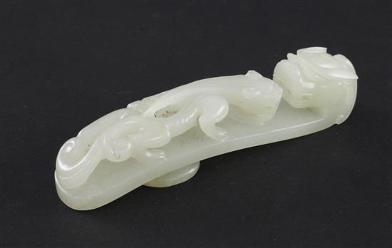 A Chinese pale celadon jade dragon belt hook, 18th / 19th century, 10cm,